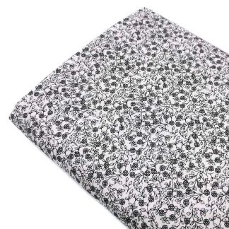 Tela de popelín 100% algodón con estampado de flores negras tamaño liberty sobre fondo color blanco. Minimals Poppy Fabrics Europe