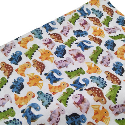 Tela de popelín con estampado de dinosaurios bebés de colores