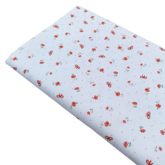 Tela de piqué de canutillo con estampado de lazos rojos y flores rojas
