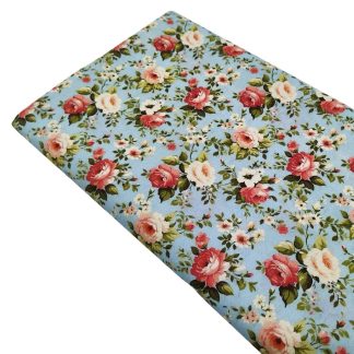 Tela de popelín con estampado de ramos de rosas de colores sobre fondo color agua