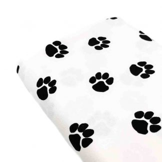Tela de loneta de algodón estampada con huellas de perro negras sobre fondo color blanco. Dog Paw Designed for you by POPPY Europe