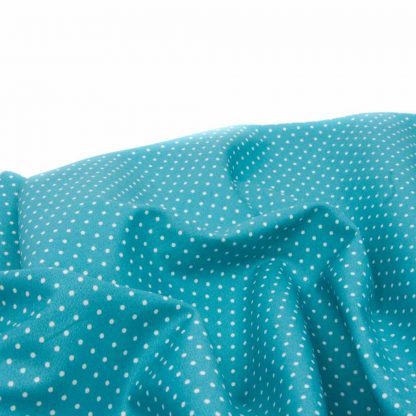 Tela de popelín 100% algodón con estampado de topos blancos pequeños sobre fondo color azul turquesa diseñado by Poppy Europe