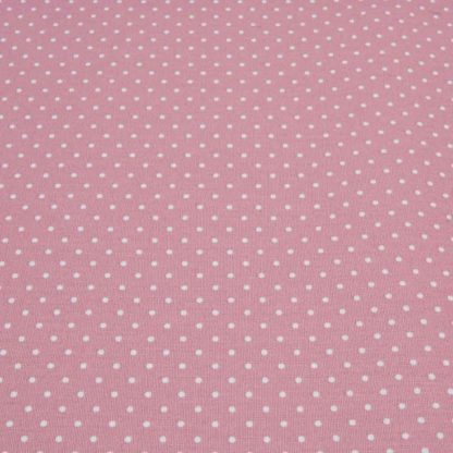 Tela de popelín 100% algodón con estampado de topos blancos pequeños sobre fondo color rosa palo diseñado by Poppy Europe