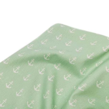 Tela de popelín 100% algodón con estampado de anclas blancas sobre fondo color verde menta diseñado by Poppy Europe