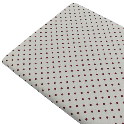 Tela de popelín estampado con lunares de color granate sobre fondo de color lino