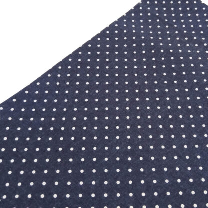 Tela de popelín estampado con lunares de color lino sobre fondo de color azul marino