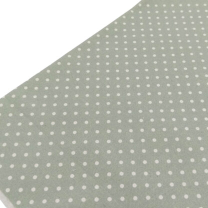 Tela de popelín estampado con lunares de color lino sobre fondo de color verde jade
