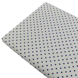 Tela de popelín estampado con lunares de color azul marino sobre fondo de color lino