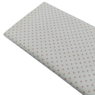 Tela de popelín estampado de estrellas rose sobre fondo color lino
