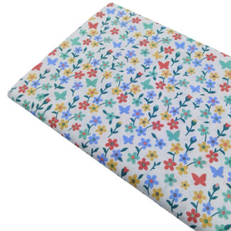 Tela de popelín con estampado de siluetas de flores de colores