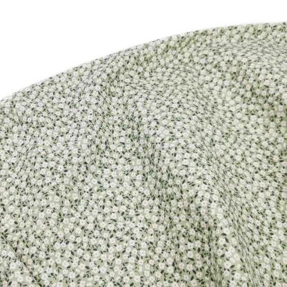 Tela viyela de algodón orgánico GOTS con estampado de flores tipo liberty blancas sobre fondo verde jade