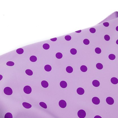 Tela bielástica especial para coser trajes de flamenca con estampado de lunares de 15 milímetros en color morado sobre fondo color malva