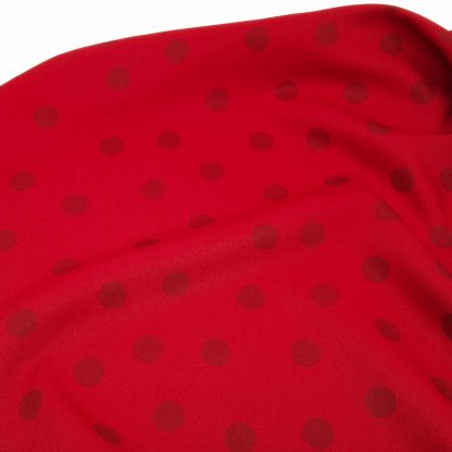 Tela bielástica especial para coser trajes de flamenca con estampado de lunares de 15 milímetros en color granate sobre fondo color rojo sangre