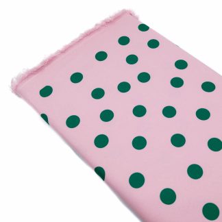 Tela bielástica especial para coser trajes de flamenca con estampado de lunares de 15 milímetros en color verde botella sobre fondo color rosa empolvado