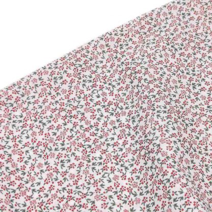 Tela batista de algodón orgánico tipo voile estampada con flores en tonos rosáceos