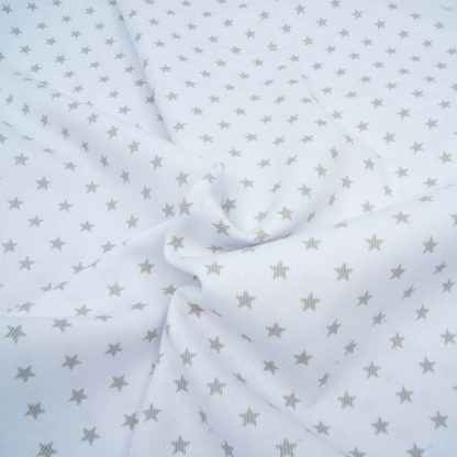 Tela de piqué de canutillo con estampado de estrellas grises sobre fondo blanco
